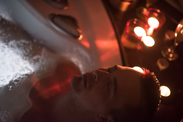 Image showing man relaxing in the jacuzzi