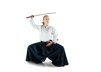 Image showing Aikido master practices defense posture. Healthy lifestyle and sports concept. Woman in white kimono on white background.