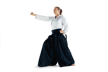 Image showing Aikido master practices defense posture. Healthy lifestyle and sports concept. Woman in white kimono on white background.