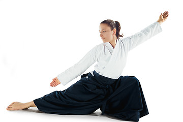 Image showing Aikido master practices defense posture. Healthy lifestyle and sports concept. Woman in white kimono on white background.