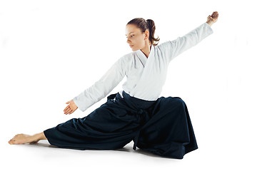 Image showing Aikido master practices defense posture. Healthy lifestyle and sports concept. Woman in white kimono on white background.