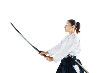 Image showing Aikido master practices defense posture. Healthy lifestyle and sports concept. Woman in white kimono on white background.