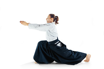 Image showing Aikido master practices defense posture. Healthy lifestyle and sports concept. Woman in white kimono on white background.
