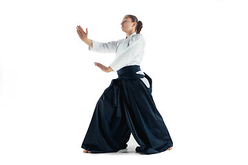 Image showing Aikido master practices defense posture. Healthy lifestyle and sports concept. Woman in white kimono on white background.