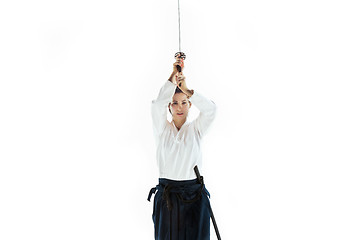 Image showing Aikido master practices defense posture. Healthy lifestyle and sports concept. Woman in white kimono on white background.