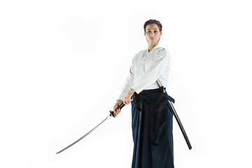 Image showing Aikido master practices defense posture. Healthy lifestyle and sports concept. Woman in white kimono on white background.