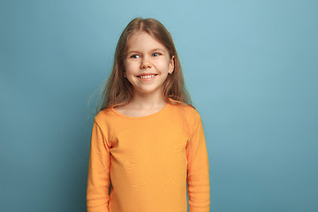 Image showing The emotional blonde teen girl have a happiness look and toothy smiling. Studio shot