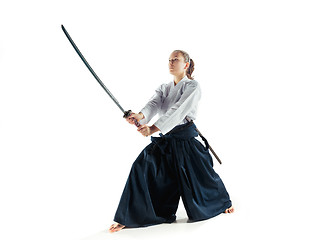 Image showing Aikido master practices defense posture. Healthy lifestyle and sports concept. Woman in white kimono on white background.