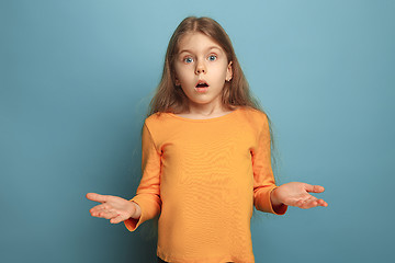 Image showing The surprise. Teen girl on a blue background. Facial expressions and people emotions concept