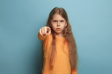 Image showing The determination. Teen girl on a blue background. Facial expressions and people emotions concept