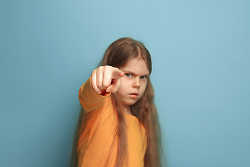 Image showing The determination. Teen girl on a blue background. Facial expressions and people emotions concept