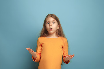 Image showing The surprise. Teen girl on a blue background. Facial expressions and people emotions concept