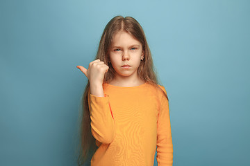 Image showing The determination. Teen girl on a blue background. Facial expressions and people emotions concept