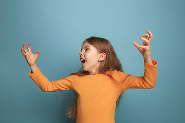 Image showing The surprise. Teen girl on a blue background. Facial expressions and people emotions concept
