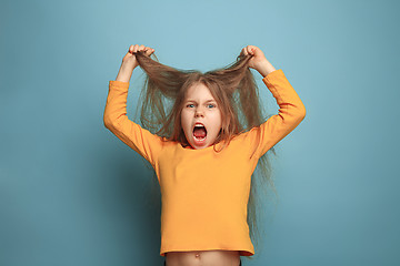 Image showing The surprise. Teen girl on a blue background. Facial expressions and people emotions concept