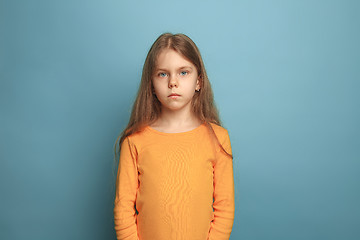 Image showing The serious teen girl on a blue background. Facial expressions and people emotions concept