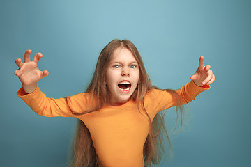 Image showing The surprise. Teen girl on a blue background. Facial expressions and people emotions concept