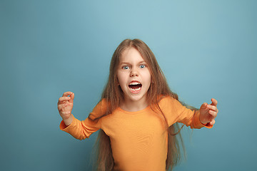 Image showing The surprise. Teen girl on a blue background. Facial expressions and people emotions concept