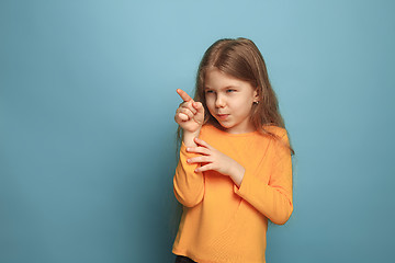 Image showing The determination. Teen girl on a blue background. Facial expressions and people emotions concept