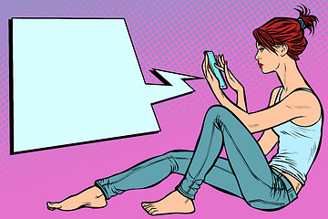 Image showing Woman sitting on the floor and reading smartphone