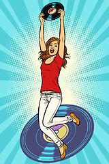 Image showing Music and vinyl. Joyful young woman jumping up