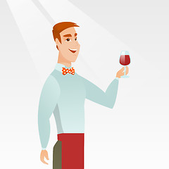 Image showing Bartender holding a glass of wine in hand.