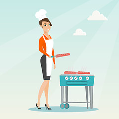 Image showing Woman cooking steak on barbecue grill.