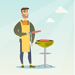 Image showing Man cooking steak on barbecue grill.