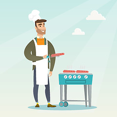 Image showing Man cooking steak on barbecue grill.