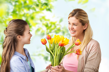 Image showing happy daughter giving flowers to mother