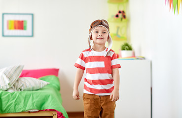 Image showing happy little boy in pilot hat at home