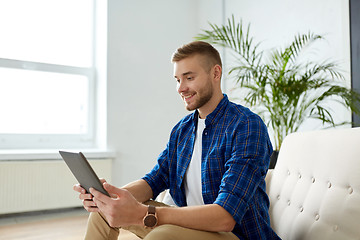 Image showing happy smiling man with tablet pc at office