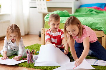 Image showing happy kids drawing at home