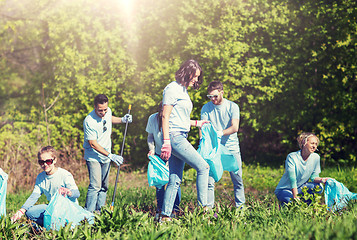 Image showing volunteers with garbage bags cleaning park area