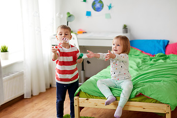 Image showing kids blowing soap bubbles and playing at home