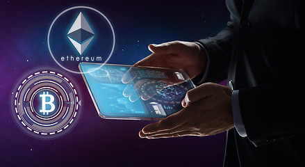 Image showing businessman with tablet pc and cryptocurrency