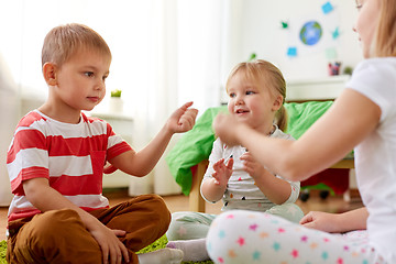 Image showing kids playing rock-paper-scissors game at home