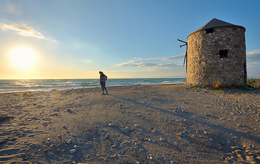 Image showing Young girl on the sunset beach