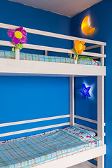 Image showing Fragment of a children\'s bunk wooden bed in the interior of the room