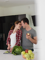 Image showing Young handsome couple in the kitchen