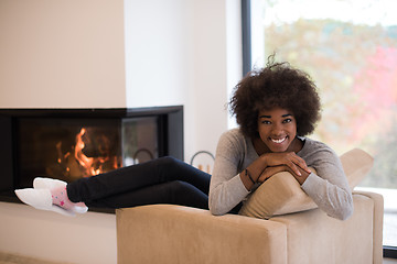 Image showing black woman in front of fireplace