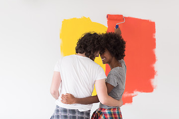 Image showing multiethnic couple painting interior wall