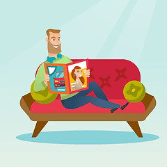 Image showing Man reading a magazine on the couch.