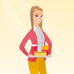 Image showing Woman holding tray full of fast food.