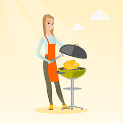 Image showing Woman cooking chicken on barbecue grill.