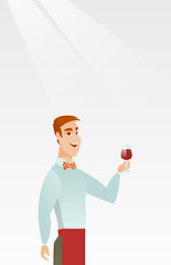 Image showing Bartender holding a glass of wine in hand.