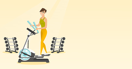 Image showing Woman exercising on elliptical trainer.