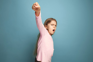 Image showing The call for struggle. Teen girl on a blue background. Facial expressions and people emotions concept