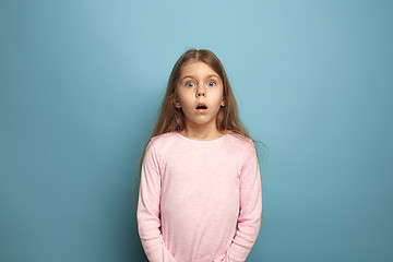 Image showing The surprise. Teen girl on a blue background. Facial expressions and people emotions concept