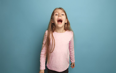 Image showing The emotional blonde teen girl have a happiness look and screaming. Studio shot